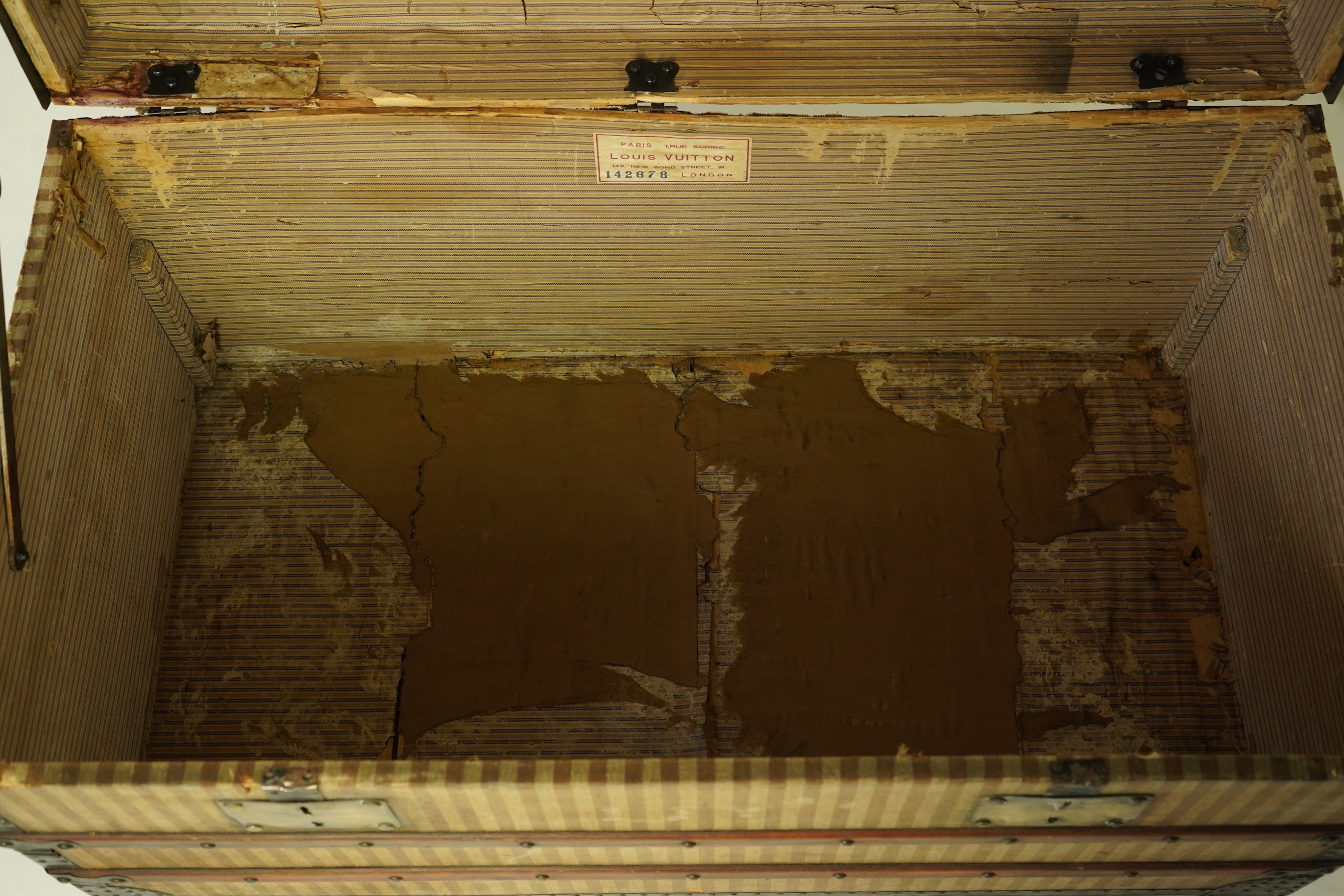 A vintage Louis Vuitton trunk with paper label to the interior numbered 142678, height 43cm, width 90cm, depth 48cm